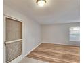 Open-concept living space featuring light wood floors and a decorative screen door at 125 Picardy Villa Cir # 100, Brandon, FL 33510