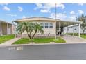 Inviting manufactured home with neat landscaping, a convenient covered parking area, and pleasant curb appeal at 12501 Ulmerton Rd # 110, Largo, FL 33774