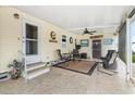 Cozy covered patio area with comfortable seating, a ceiling fan, and space to relax and enjoy the outdoors at 12501 Ulmerton Rd # 110, Largo, FL 33774