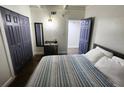 Bedroom featuring a bed with a striped quilt, a closet, and a dresser with a mirror at 1335 Waikiki Way, Tampa, FL 33619