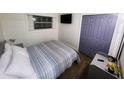 Cozy bedroom with window, television, and closet at 1335 Waikiki Way, Tampa, FL 33619