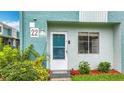 A close exterior perspective featuring a two-story townhome's front door and adjacent garden at 147 114Th Ne Ave # 147, St Petersburg, FL 33716