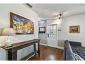 Inviting living room with hardwood floors, a rustic console table, and a bright white front door at 150 Bosphorous Ave, Tampa, FL 33606