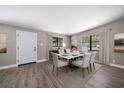 Bright dining room featuring a modern table set, wood floors, and neutral wall color at 1501 Howard Pl, Largo, FL 33770