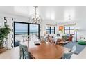 Bright living room with ocean views, a dining table, and coastal-inspired decor at 17334 Gulf Blvd # 203, North Redington Beach, FL 33708