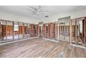 Spacious living room showing the new flooring and exposed framing ready for renovation at 1841 Douglas Ave, Dunedin, FL 34698