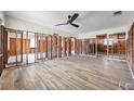 Spacious living room featuring new wood-look floors and a modern ceiling fan at 1841 Douglas Ave, Dunedin, FL 34698