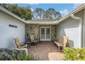 Covered porch with stone accents, seating area and double door entryway at 2222 Westchester Blvd, Spring Hill, FL 34606