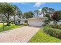 Wide view of home with long brick driveway and green landscaping at 2222 Westchester Blvd, Spring Hill, FL 34606