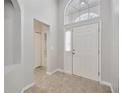 Bright foyer features a tiled floor, high ceilings, and a window above the white front door at 25101 Hyde Park Blvd, Land O Lakes, FL 34639