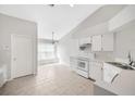 The eat-in kitchen features tiled flooring, white appliances, and a ceiling fan at 25101 Hyde Park Blvd, Land O Lakes, FL 34639