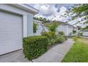 Home featuring a well-maintained lawn, driveway, and a two car garage, providing ample parking at 26343 Whirlaway Ter, Wesley Chapel, FL 33544