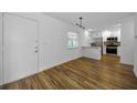 View of the home's entry into the living room and renovated kitchen with breakfast bar at 2700 Bayshore Blvd # 5307, Dunedin, FL 34698
