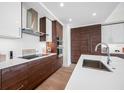 Modern kitchen featuring custom wood cabinetry, stainless steel appliances, and a sleek white countertop at 301 1St S St # 1906, St Petersburg, FL 33701