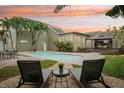 Outdoor pool area with nice chairs and umbrella perfect for relaxation on a hot day at 333 30Th N Ave, St Petersburg, FL 33704