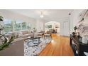 Bright living room featuring hardwood floors, large windows, and an open floor plan that leads to the dining room at 333 30Th N Ave, St Petersburg, FL 33704