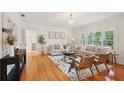 Well-lit living room featuring hardwood floors, white walls, and large windows with plantation shutters at 333 30Th N Ave, St Petersburg, FL 33704