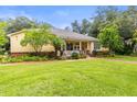Beautifully landscaped home with lush greenery and a brick walkway at 3402 Melissa Country Way, Lutz, FL 33559