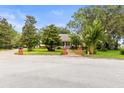 Charming home nestled among lush trees and a well manicured lawn at 3402 Melissa Country Way, Lutz, FL 33559
