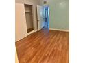 Bedroom with wood-look floors and a closet provides ample storage at 4020 55Th N St # 1106, Kenneth City, FL 33709
