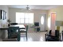 Inviting dining room with a large window, neutral tile flooring, and a stylish dining set at 413 Lake Point Ct # 4B, Sun City Center, FL 33573