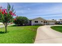 Single-story home with a well-maintained lawn and circular driveway, showcasing vibrant landscaping at 4300 31St N Ave, St Petersburg, FL 33713