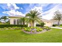 Inviting home featuring lush landscaping, a manicured lawn, and a two-car garage at 4304 Place Le Manes, Lutz, FL 33558