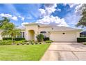 Attractive single-story home featuring a well-manicured lawn and lush landscaping at 4304 Place Le Manes, Lutz, FL 33558