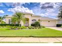 Beautiful single-story home featuring lush landscaping and a well-maintained lawn at 4304 Place Le Manes, Lutz, FL 33558