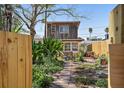 Charming two-story home with lush landscaping, privacy fence and brick walkway at 44 77Th Ave, Treasure Island, FL 33706