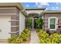 Inviting front entryway adorned with lush landscaping and a covered porch, creating a warm welcome at 4505 Anaconda Dr, New Port Richey, FL 34655