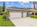 Spacious three-car garage with a long driveway, set against a backdrop of well-manicured landscaping at 4505 Anaconda Dr, New Port Richey, FL 34655