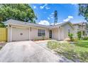 Beautiful one-story home featuring an attached garage, new landscaping, and a modern front door at 4605 W Loughman St, Tampa, FL 33616