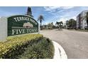 Entrance sign to Terrace Park of Five Towns, a picturesque community with lush greenery and palm trees at 5920 80Th N St # 406, St Petersburg, FL 33709