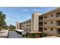 Multi-story building with balconies, flagpole and parking, ideal for convenient community living at 5920 80Th N St # 406, St Petersburg, FL 33709