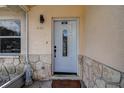 Inviting front entrance with a decorative door, stone accents and stylish lighting fixture at 6460 101St N Ave, Pinellas Park, FL 33782