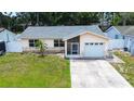 Inviting one-story home with stone accents, green lawn and convenient attached garage at 6460 101St N Ave, Pinellas Park, FL 33782