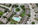 Aerial view of community featuring a blue pool, lush landscaping, and convenient parking at 6940 47Th N Way, Pinellas Park, FL 33781