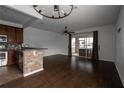 Spacious living area with hardwood floors, an elegant chandelier, and sliding glass doors to the outdoors at 6940 47Th N Way, Pinellas Park, FL 33781