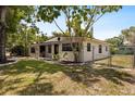 Single story home featuring an updated yard, new landscaping, and a chain-link fence at 8009 Somerset Ln, Tampa, FL 33615