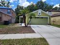 Inviting home showcasing landscaping, a green exterior, and a well-maintained lawn at 8313 Arabian Dunes Pl, Riverview, FL 33578