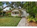 Charming bungalow featuring mature landscaping, covered front porch, and inviting curb appeal at 848 9Th S Ave, St Petersburg, FL 33701