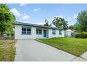 Charming single story home with well manicured front lawn and long concrete driveway at 109 Magnolia Ave, Seffner, FL 33584