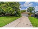 Charming home with a well-manicured lawn and a long driveway leading to a two-car garage at 117 Connie Ave, Tampa, FL 33613