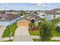 Well-maintained home featuring a two-car garage, lush landscaping, and a manicured lawn at 11837 Thicket Wood Dr, Riverview, FL 33579