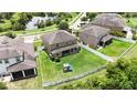 Aerial view of a spacious backyard featuring a well-maintained lawn, white fence and a play structure at 12316 Streambed Dr, Riverview, FL 33579