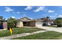 Lovely single-Gathering home boasting a lush green lawn and attached one car garage at 12804 Millridge Forest St, Tampa, FL 33624