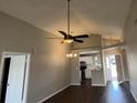Inviting living area features soaring ceilings and hardwood floors, leading to the kitchen at 12804 Millridge Forest St, Tampa, FL 33624