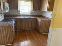 Functional kitchen featuring laminate countertops and ample wood-look cabinetry at 15034 Lake Magdalene Blvd, Tampa, FL 33618