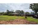Exterior of home with a spacious yard and a dark vehicle in the driveway at 19036 Blake Rd, Odessa, FL 33556